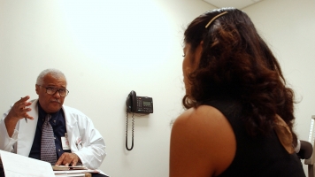 A doctor talks to a female patient.