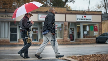 A black man carries a firearm during an open-carry event in Ferguson, Missouri.