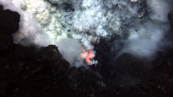 An undersea volcano erupts.