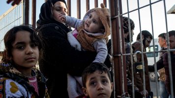 Syrian family seeking refuge by crossing the Turkish border