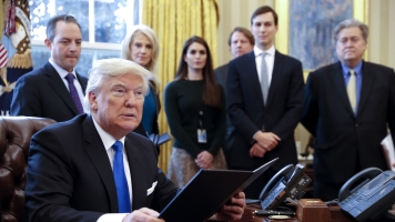 President Donald Trump at his Oval Office desk