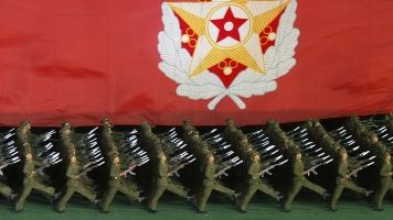 North Korean military cadets hold a North Korean leader Kim Jong-Il's flag.