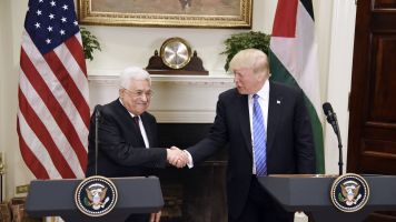 President Donald Trump shakes Palestinian President Mahmoud Abbas's hand