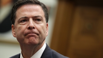 FBI Director James Comey sits at a table.