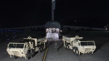 Two THAAD launchers sit on a runway