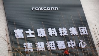 Foxconn employee puts up scaffolding