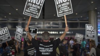 Activists protest travel ban outside LAX.