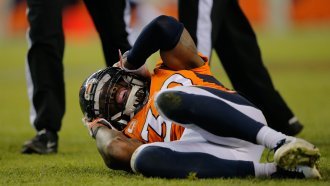 Former Denver Broncos safety David Bruton lies on the ground after a hit