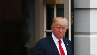 US President Donald Trump walks out of the White House.