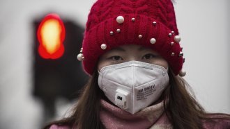 A Chinese woman wears a mask to protect against pollution.