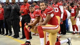 Colin Kaepernick and Eric Reid kneel in protest during the national anthem.