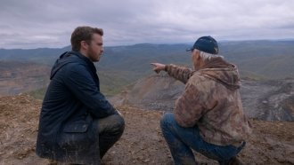 Reporter Zach Toombs and retired coal miner Chuck Nelson overlook a mountaintop removal site.