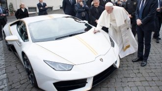 Pope Francis is presented with a special edition Lamborghini.