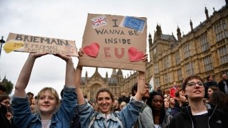 Anti-Brexit protesters hold up signs