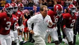 Nick Saban takes the field with his University of Alabama football team.