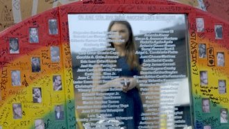 Liz Wahl stands at a memorial for the Pulse nightclub shooting in Orlando, Florida.