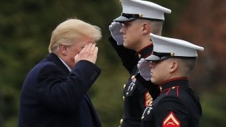 President Donald Trump salutes service members