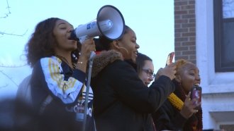 High school students from Kenwood Academy in Chicago, Illinois, rally outside their school on March 14, 2018.