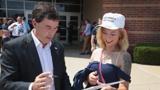 Republican Troy Balderson greets a Trump supporter ahead of a rally with the president.
