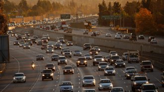 Cars travel on the 210 freeway in California
