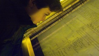 Ethan Kasnett, an 8th grade student at the Lab School in Washington, DC, views the original constitution after a ceremony.