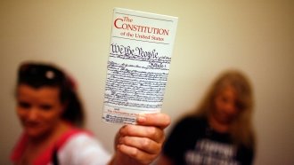 A woman holds a copy of the Constitution
