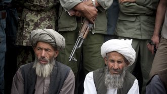 Members of the Taliban surrender themselves to the Afghan government