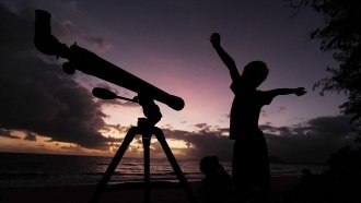 A young boy gets ready to view the solar eclipse with his telescope on November 14, 2012 in Palm Cove, Australia.