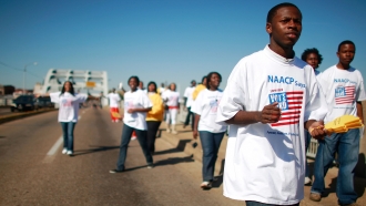 College students march across the iconic Edmund Pettis Bridge in Alabama to encourage people to vote in the 2008 election.