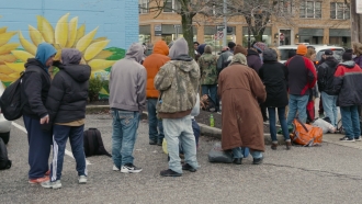 Homeless line up outside the Northern Kentucky Emergency Shelter in Covington, KY.