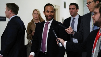 Former Trump campaign adviser George Papadopoulos (C) arrives at a closed door hearing before Congress.