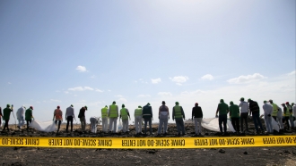Forensics investigators collect items from the crash site of Ethiopian Airlines Flight ET 302 on March 12, 2019 in Ethiopia