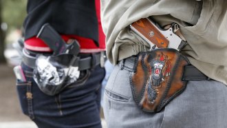 Two people with holstered handguns