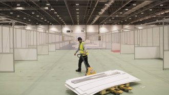 Work continues at the ExCel centre, which is being made into a temporary hospital in London.