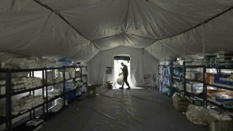 A U.S. Army soldier walks inside a mobile surgical unit.