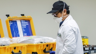 A worker handles medical equipment