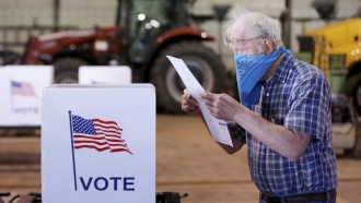 Person wears mask at polling place