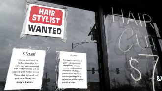 A barber shop shows closed and hiring sign during the COVID-19 pandemic.