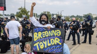 A protester holds a sign during the Good Trouble Tuesday march for Breonna Taylor.
