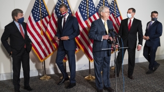 Senate Majority Leader Mitch McConnell of Ky., center, approaches the microphones accompanied by, from left, Sen. Roy Blunt,