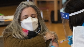 Teacher Lisa Egan is vaccinated with the Moderna coronavirus vaccine at a clinic in New York City