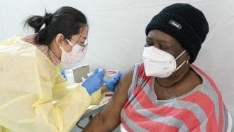 NYC: Woman gets COVID-19 vaccine