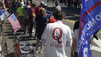 A man in QAnon T-shirt waits for President Donald Trump to arrive in Old Forge, Pennsylvania