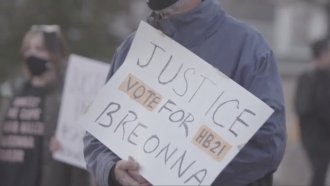 Activist holds Breonna's Law sign