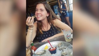 Woman eating oysters.
