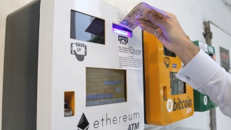 A person uses an Ethereum ATM