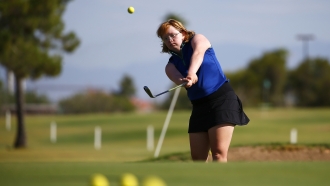 Amy Bockerstette practices with her teaching pro at Palmbrook Country Club