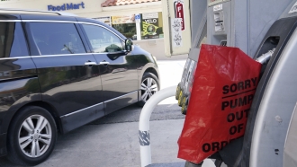 A customer drives from a Chevron station after it ran out of gasoline, Wednesday, May 12, 2021, in Miami.