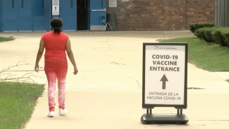 Woman heads inside a vaccine site