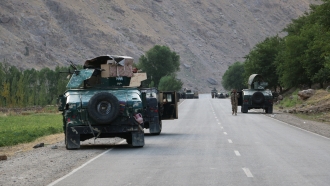 Afghan soldiers in vehicles pause on a road in northern Afghanistan.